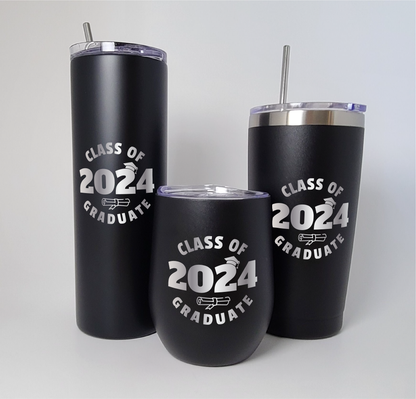 Three laser engraved tumblers displayed against a white backdrop. Each tumbler features the graduation year in the center, adorned with a graduation cap atop the number and a diploma beneath it. The words 'Class of' and 'Graduate' flank the year, beautifully engraved onto the surface of each tumbler.