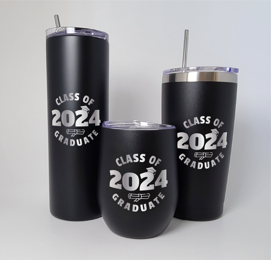 Three laser engraved tumblers displayed against a white backdrop. Each tumbler features the graduation year in the center, adorned with a graduation cap atop the number and a diploma beneath it. The words 'Class of' and 'Graduate' flank the year, beautifully engraved onto the surface of each tumbler.